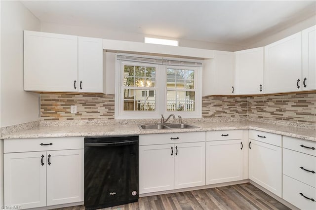 kitchen with sink, decorative backsplash, black dishwasher, dark hardwood / wood-style flooring, and white cabinetry