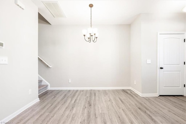 unfurnished dining area with light wood-style floors, visible vents, baseboards, and stairs