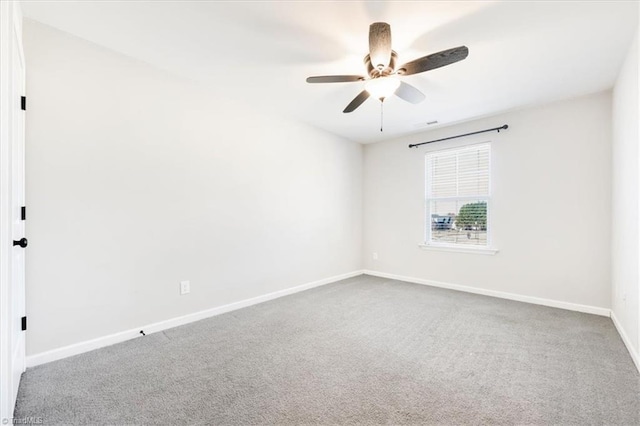 spare room featuring ceiling fan, baseboards, and carpet flooring