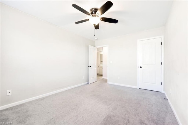 unfurnished bedroom featuring baseboards, a ceiling fan, and light colored carpet