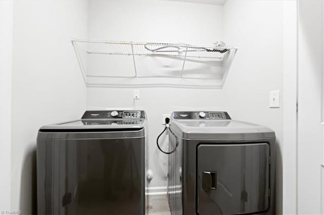 clothes washing area featuring laundry area and washer and dryer