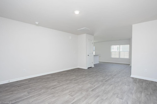 unfurnished room with light wood-type flooring