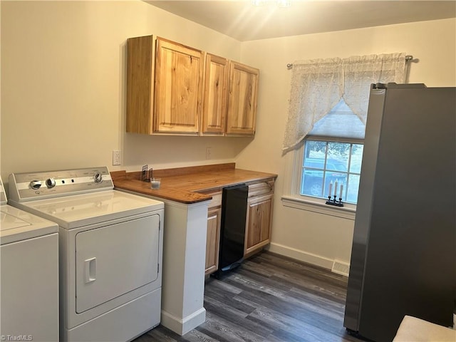 laundry room with washing machine and dryer and dark wood-type flooring