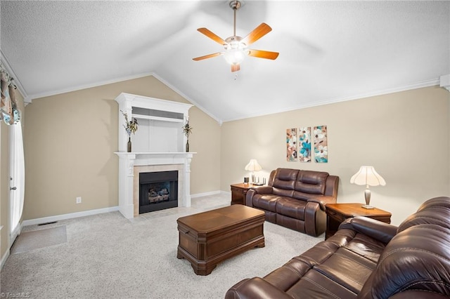 269 Country Villa Dr, Lexington, NC 27295 - carpeted living room featuring ceiling fan, vaulted ceiling, a fireplace with flush hearth, baseboards, and ornamental molding