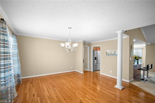 269 Country Villa Dr, Lexington, NC 27295 - unfurnished room featuring light wood-style floors, a textured ceiling, decorative columns, ornamental molding, and plenty of natural light
