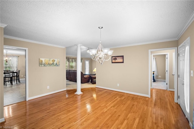 269 Country Villa Dr, Lexington, NC 27295 - unfurnished dining area with a chandelier, decorative columns, light wood finished floors, crown molding, and a textured ceiling