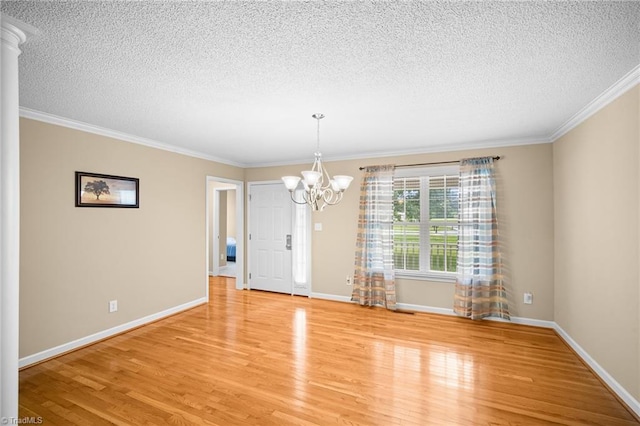 269 Country Villa Dr, Lexington, NC 27295 - unfurnished dining area with a textured ceiling, light wood-style flooring, ornamental molding, a chandelier, and baseboards