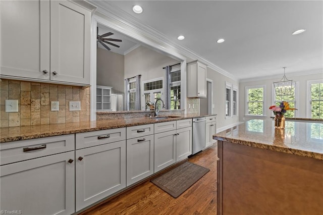 2507 Duck Club Rd, Greensboro, NC 27410 - kitchen featuring stainless steel dishwasher, wood finished floors, crown molding, recessed lighting, and decorative backsplash