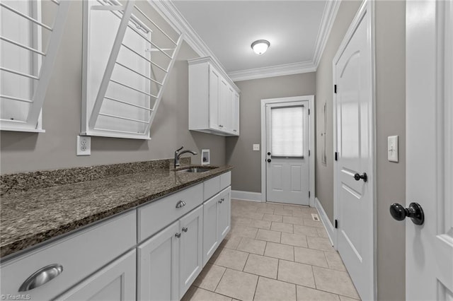 2507 Duck Club Rd, Greensboro, NC 27410 - laundry room with hookup for a washing machine, cabinet space, crown molding, and light tile patterned flooring