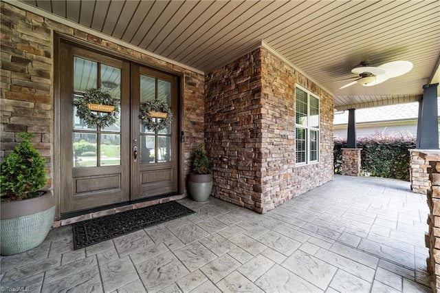 2507 Duck Club Rd, Greensboro, NC 27410 - entrance to property featuring french doors, a porch, ceiling fan, and stone siding