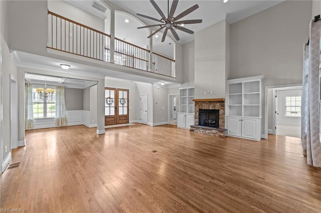 2507 Duck Club Rd, Greensboro, NC 27410 - unfurnished living room with ceiling fan, a chandelier, crown molding, wood finished floors, and a towering ceiling