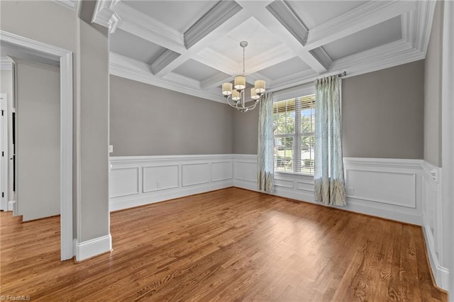 2507 Duck Club Rd, Greensboro, NC 27410 - spare room with a chandelier, coffered ceiling, beam ceiling, wood finished floors, and crown molding