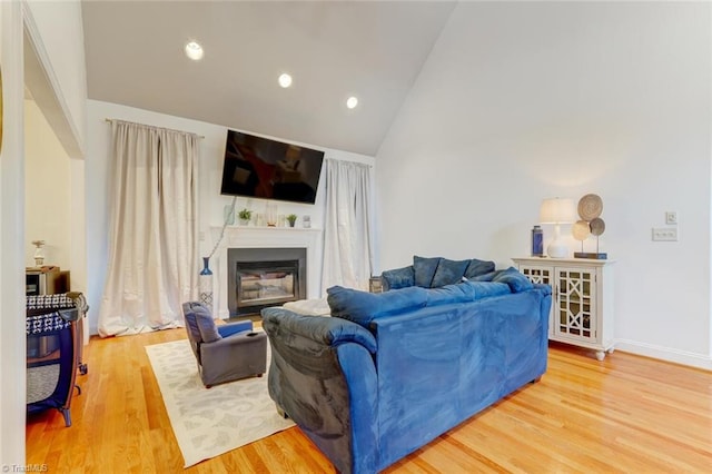 living room with high vaulted ceiling and wood-type flooring