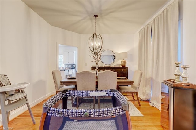 dining space featuring a notable chandelier and hardwood / wood-style floors