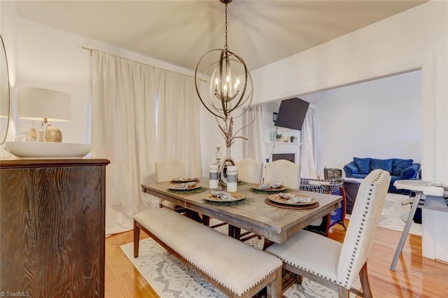 dining area featuring a notable chandelier and hardwood / wood-style floors