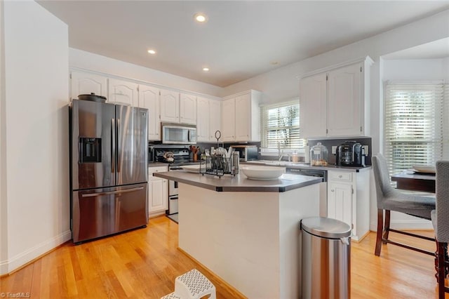 kitchen featuring light hardwood / wood-style floors, white cabinetry, and appliances with stainless steel finishes