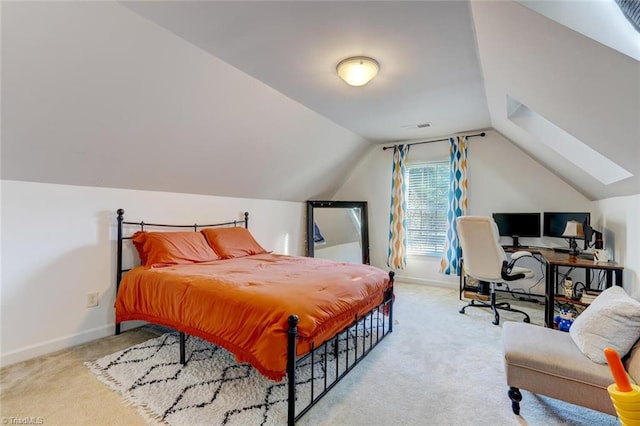 bedroom featuring vaulted ceiling and light colored carpet