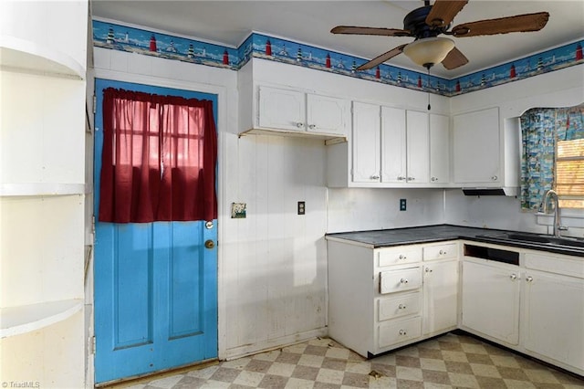 kitchen featuring ceiling fan, sink, white cabinets, and a healthy amount of sunlight