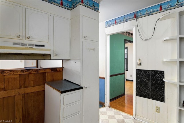 kitchen with light wood-type flooring and white cabinetry