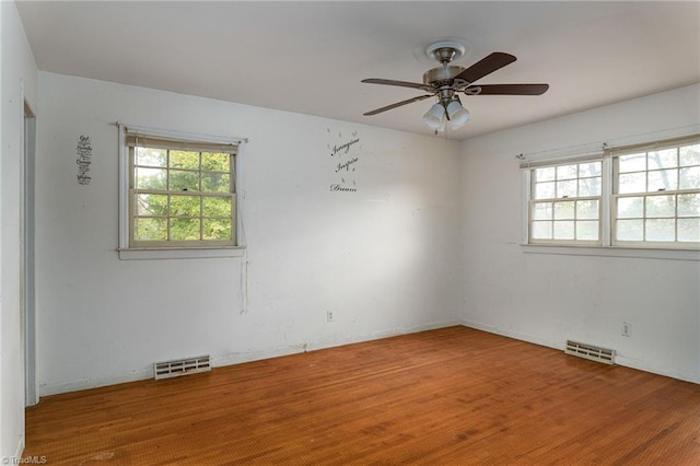 spare room with hardwood / wood-style floors and ceiling fan