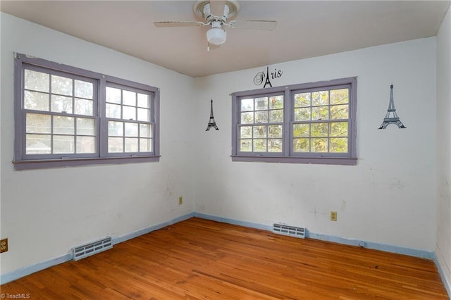 unfurnished room featuring ceiling fan, light hardwood / wood-style floors, and a wealth of natural light