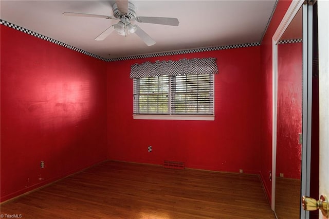 spare room with hardwood / wood-style floors and ceiling fan