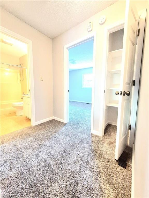 1018 Cedar Place Ct, Winston-Salem, NC 27107 - unfurnished bedroom featuring carpet flooring, a textured ceiling, baseboards, and ensuite bath