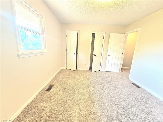 1018 Cedar Place Ct, Winston-Salem, NC 27107 - unfurnished bedroom featuring a textured ceiling, light carpet, and baseboards