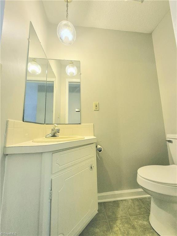 1018 Cedar Place Ct, Winston-Salem, NC 27107 - bathroom with vanity, toilet, baseboards, and tile patterned flooring