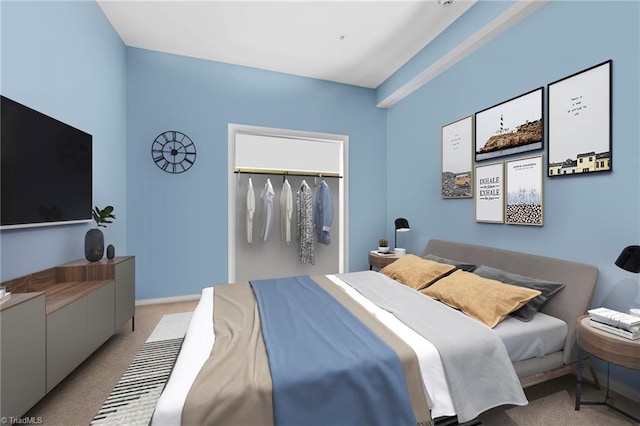 bedroom featuring light colored carpet, a walk in closet, and a closet