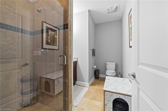 bathroom featuring tile patterned flooring, toilet, and walk in shower