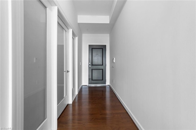 corridor featuring dark hardwood / wood-style flooring