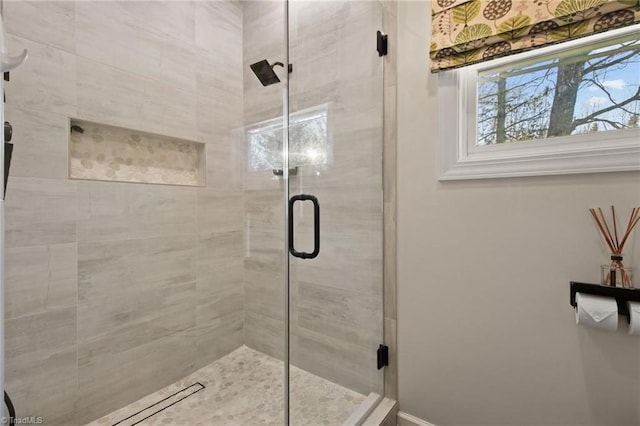 bathroom featuring a shower with door