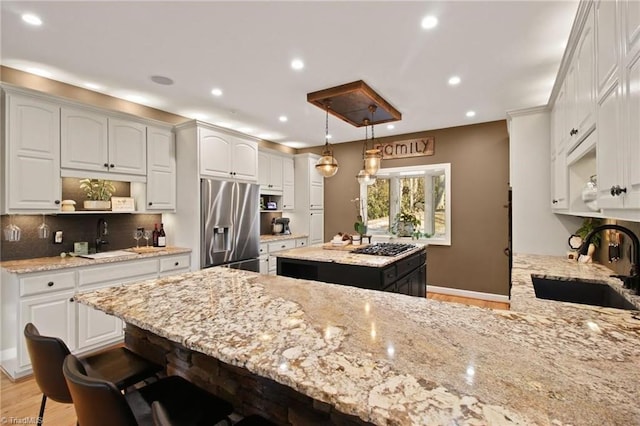 kitchen featuring sink, stainless steel appliances, and white cabinetry