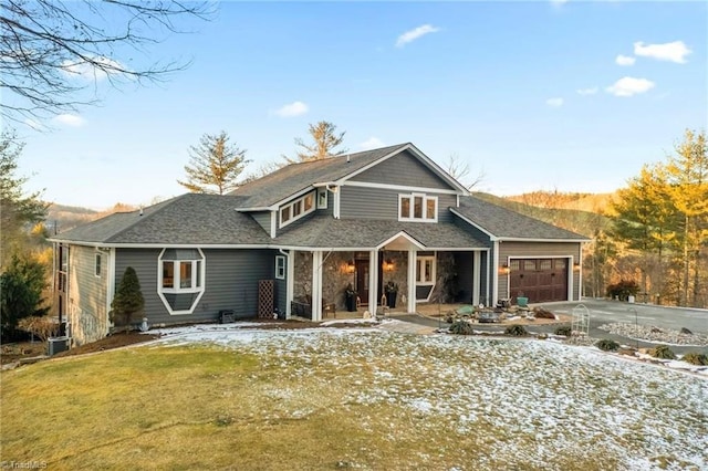 view of front of home featuring a garage and a lawn