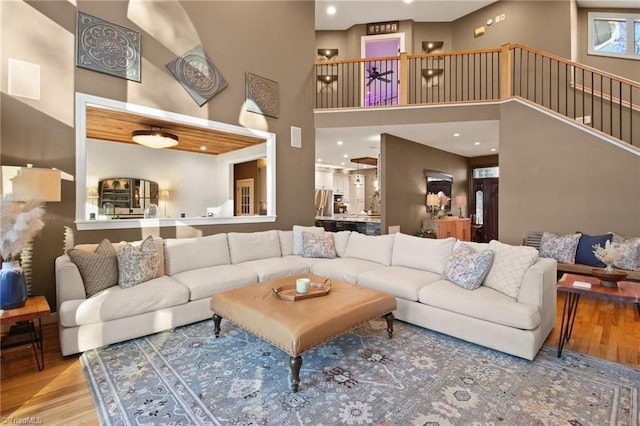 living room featuring hardwood / wood-style floors and a towering ceiling