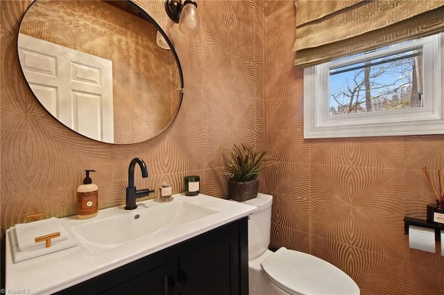 bathroom with toilet and vanity