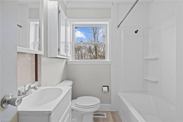 full bathroom featuring toilet, crown molding, wood-type flooring, shower / bathtub combination, and vanity