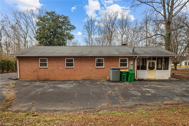 back of house with central AC and a sunroom