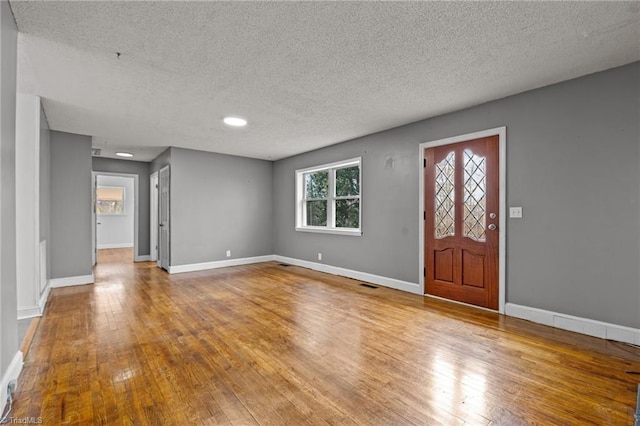 foyer with hardwood / wood-style floors and a textured ceiling