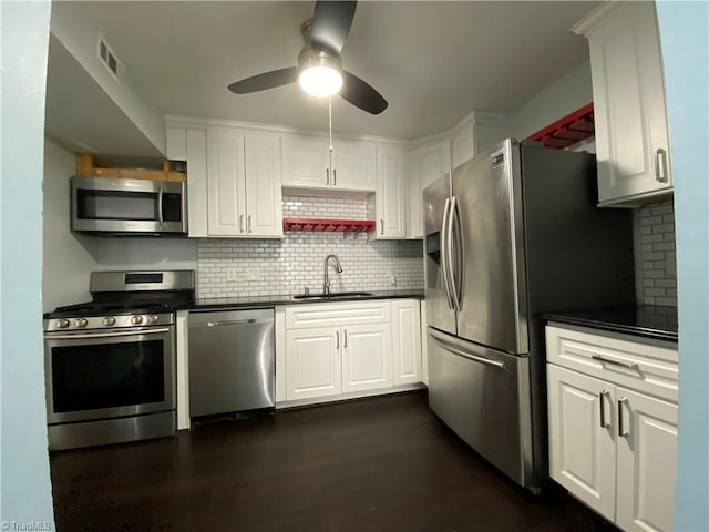 2821 Bleeker Sq Unit E, Winston-Salem, NC 27106 - kitchen with appliances with stainless steel finishes, a sink, dark countertops, ceiling fan, and decorative backsplash