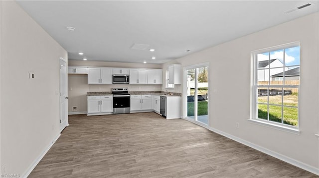 3765 Baden Rd, Winston-Salem, NC 27107 - kitchen with light wood-type flooring, appliances with stainless steel finishes, and a healthy amount of sunlight