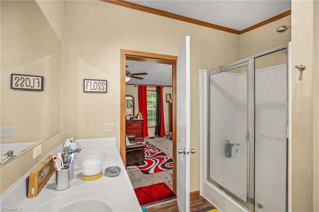 1030 Endeavour Ln, Walnut Cove, NC 27052 - bathroom with crown molding, a stall shower, double vanity, a textured ceiling, and ceiling fan