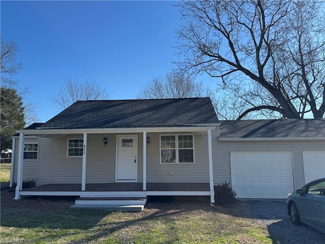 view of front of house with covered porch, driveway, roof with shingles, and an attached garage