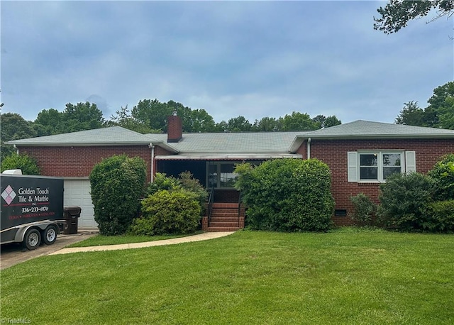 422 Manor Dr, High Point, NC 27260 - view of front of property featuring brick siding, a front lawn, a chimney, and an attached garage