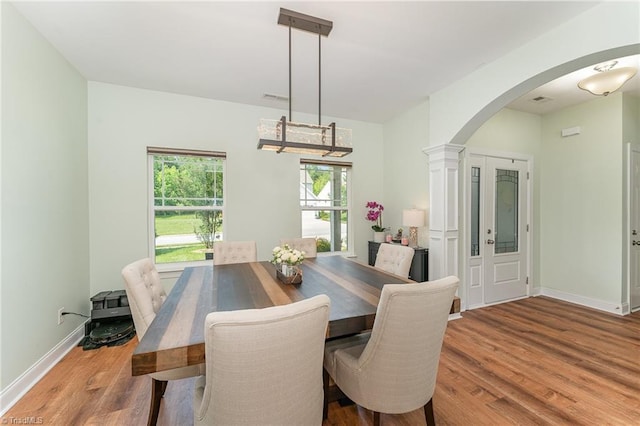 2452 Tannin Ct, High Point, NC 27265 - dining area with arched walkways, wood finished floors, and a chandelier