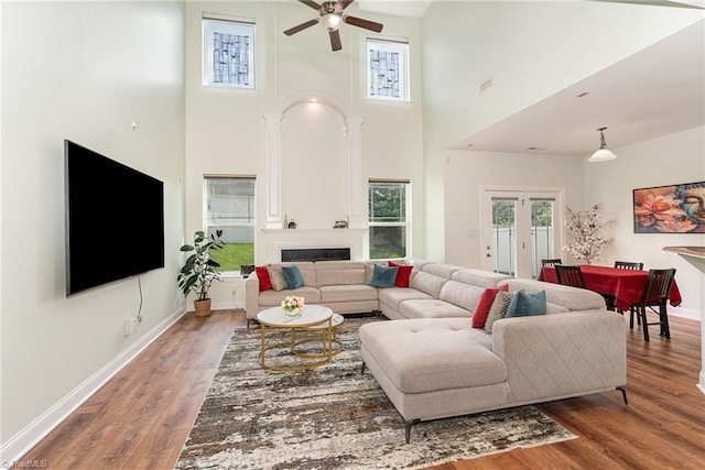 2452 Tannin Ct, High Point, NC 27265 - living area with a ceiling fan, a towering ceiling, wood finished floors, and a fireplace