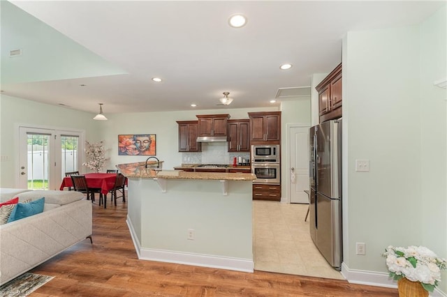 2452 Tannin Ct, High Point, NC 27265 - kitchen with stainless steel appliances, a kitchen breakfast bar, recessed lighting, light stone countertops, and a large island
