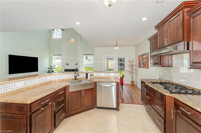 2452 Tannin Ct, High Point, NC 27265 - kitchen with stainless steel appliances, vaulted ceiling, light stone countertops, plenty of natural light, and tasteful backsplash