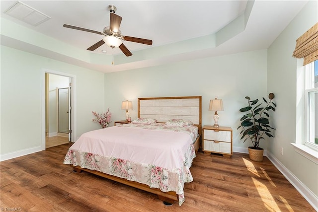 2452 Tannin Ct, High Point, NC 27265 - bedroom featuring a raised ceiling, wood finished floors, and ceiling fan